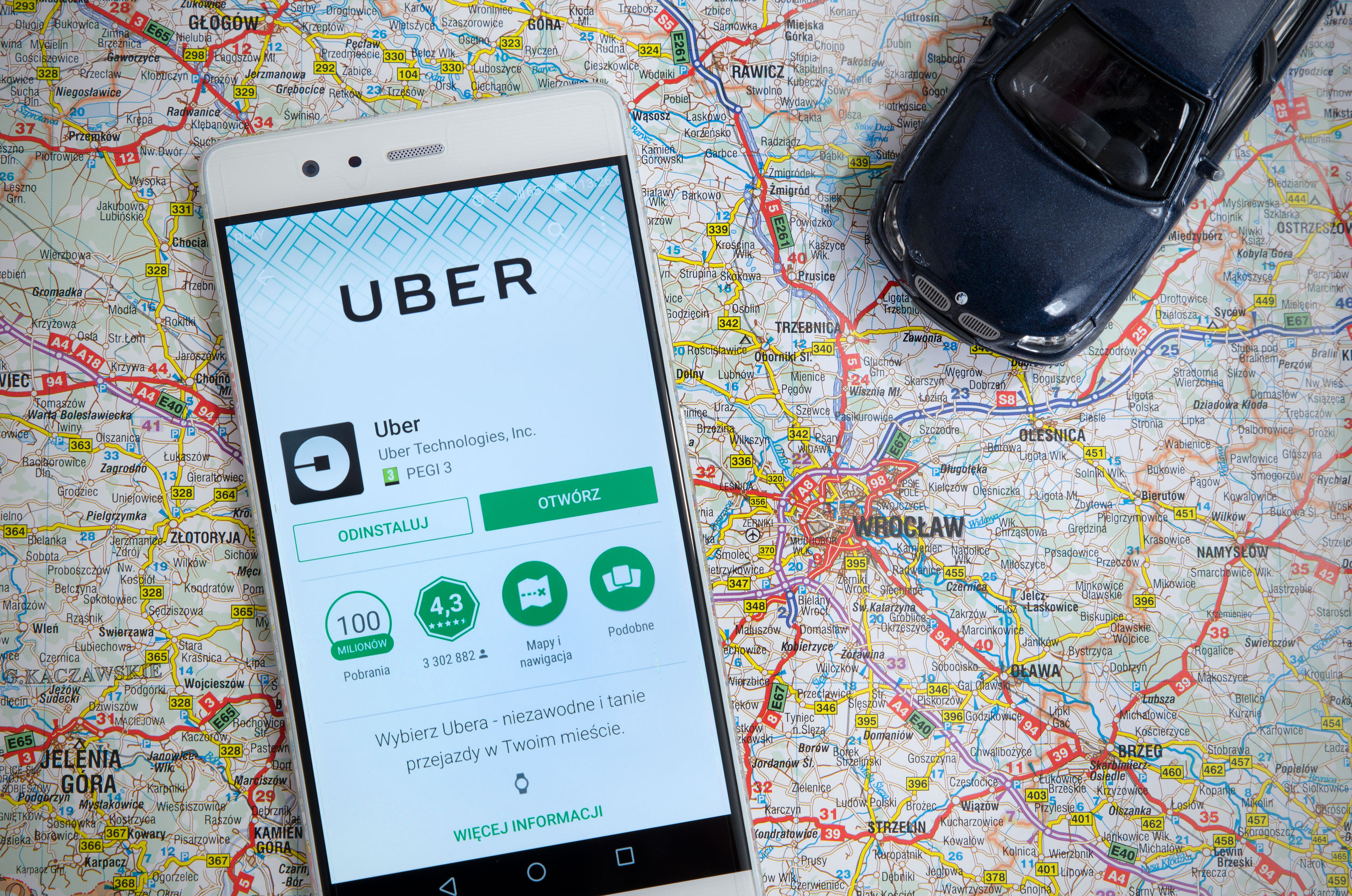 Is Uber Dangerous to Women, smartphone with Uber app on a map of a city